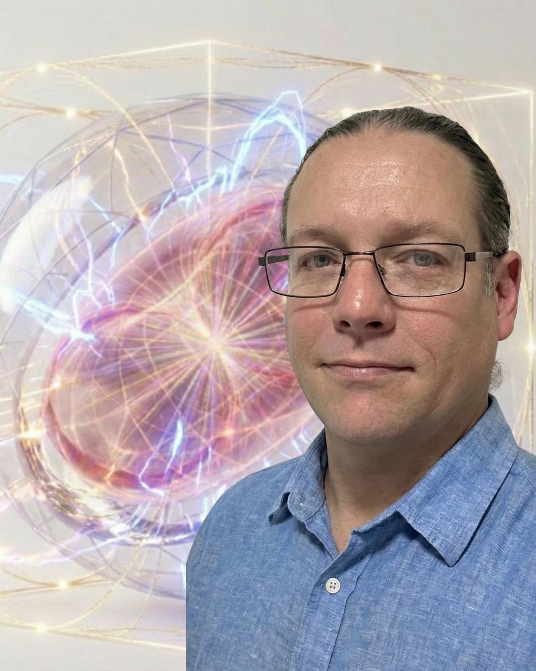 Luke Nathan Hayes wearing glasses and a blue collared shirt
