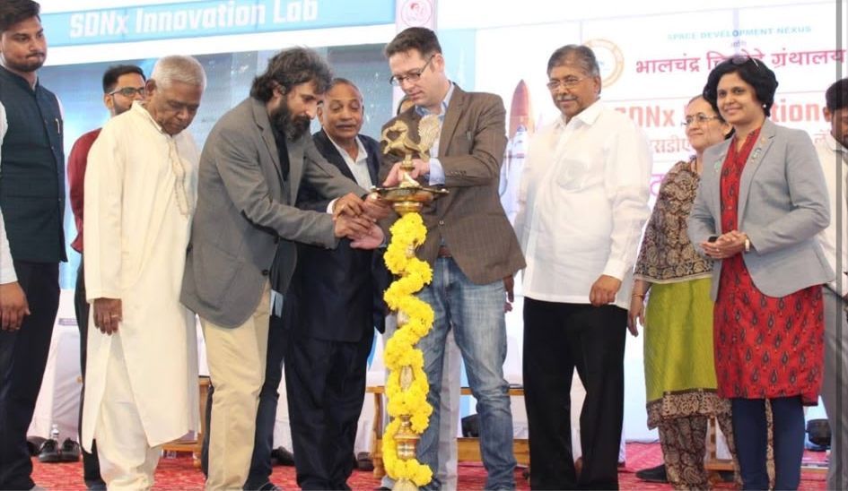 The lamp-lighting inauguration of the SDNx Innovation Lab, with guests gathered around the lamp