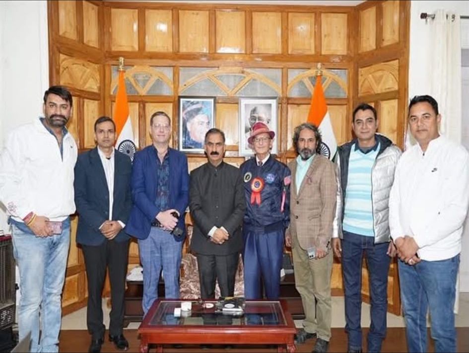 Group photograph at the Chief Minister's residence in Shimla, Indian flags and portraits behind