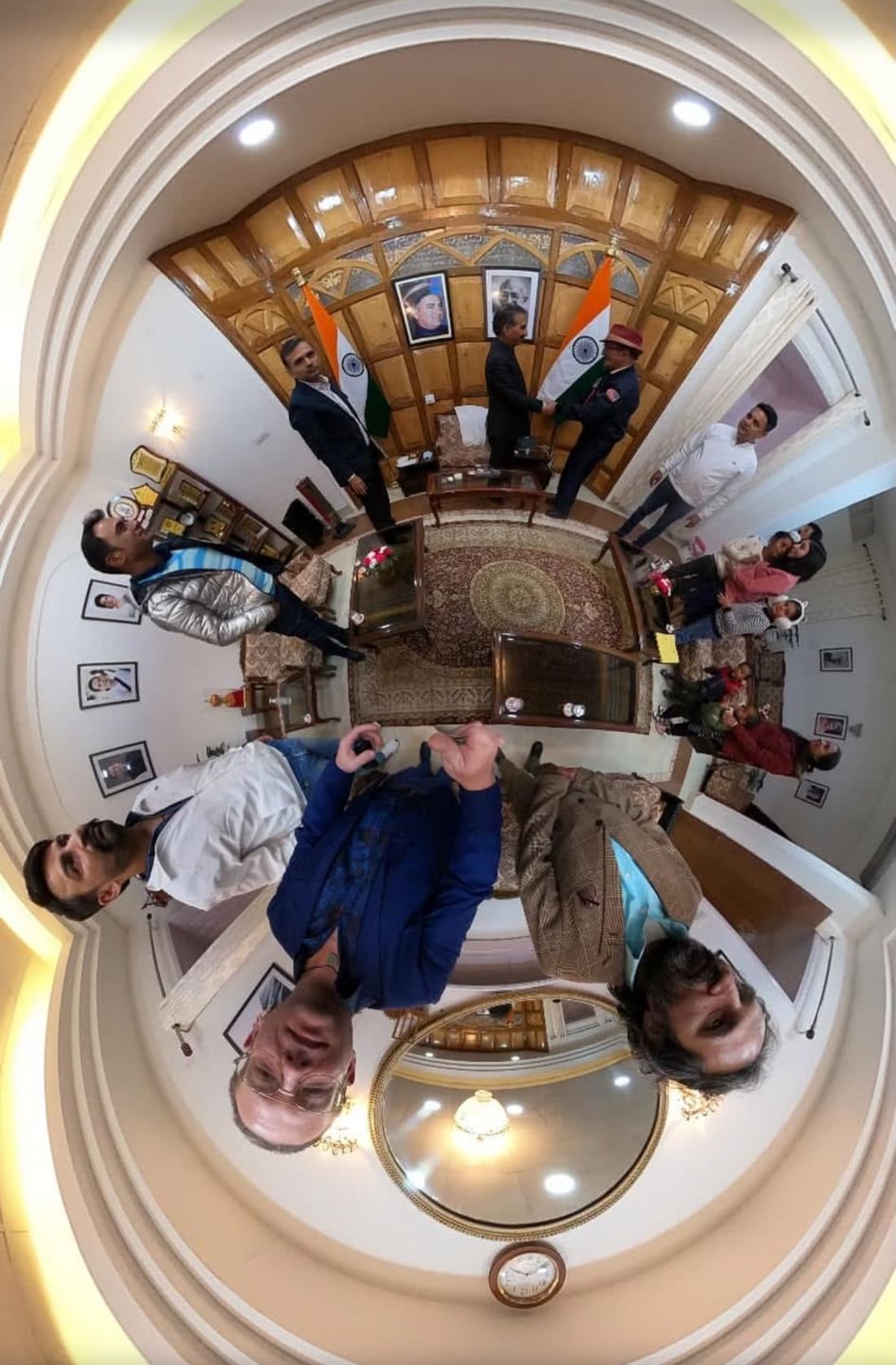 A 360-degree tiny-planet photograph of the same room, curving the walls and ceiling into a sphere